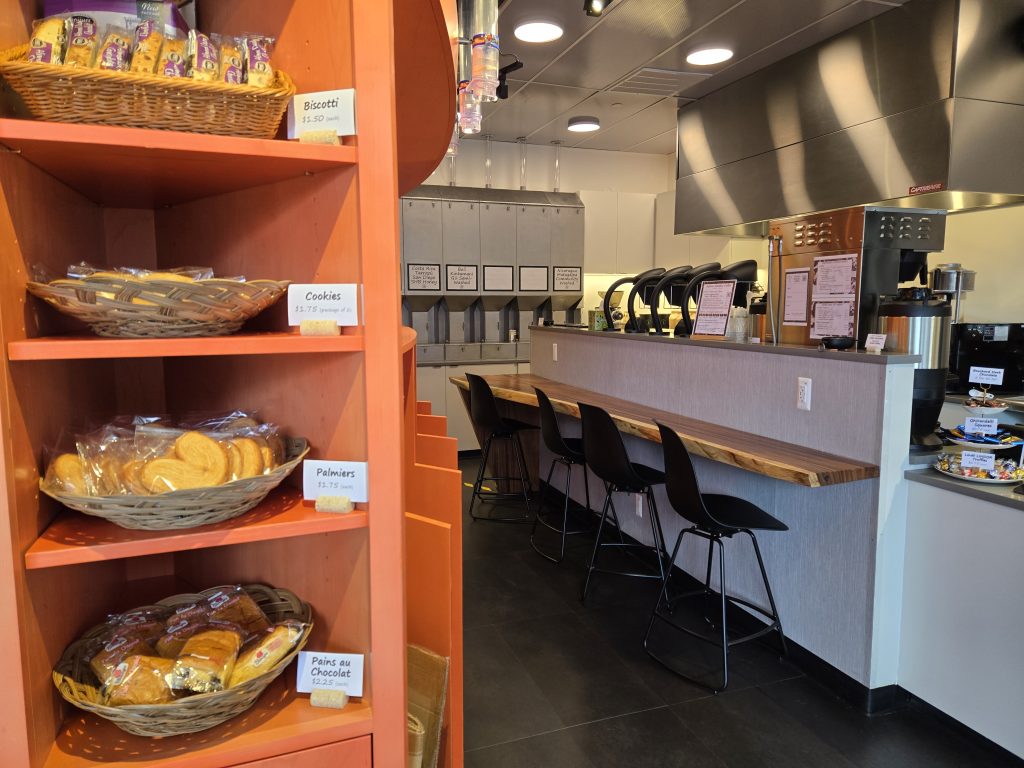 Selection of baked goods, to the side of the customer counter (5 seats) and coffee brewers